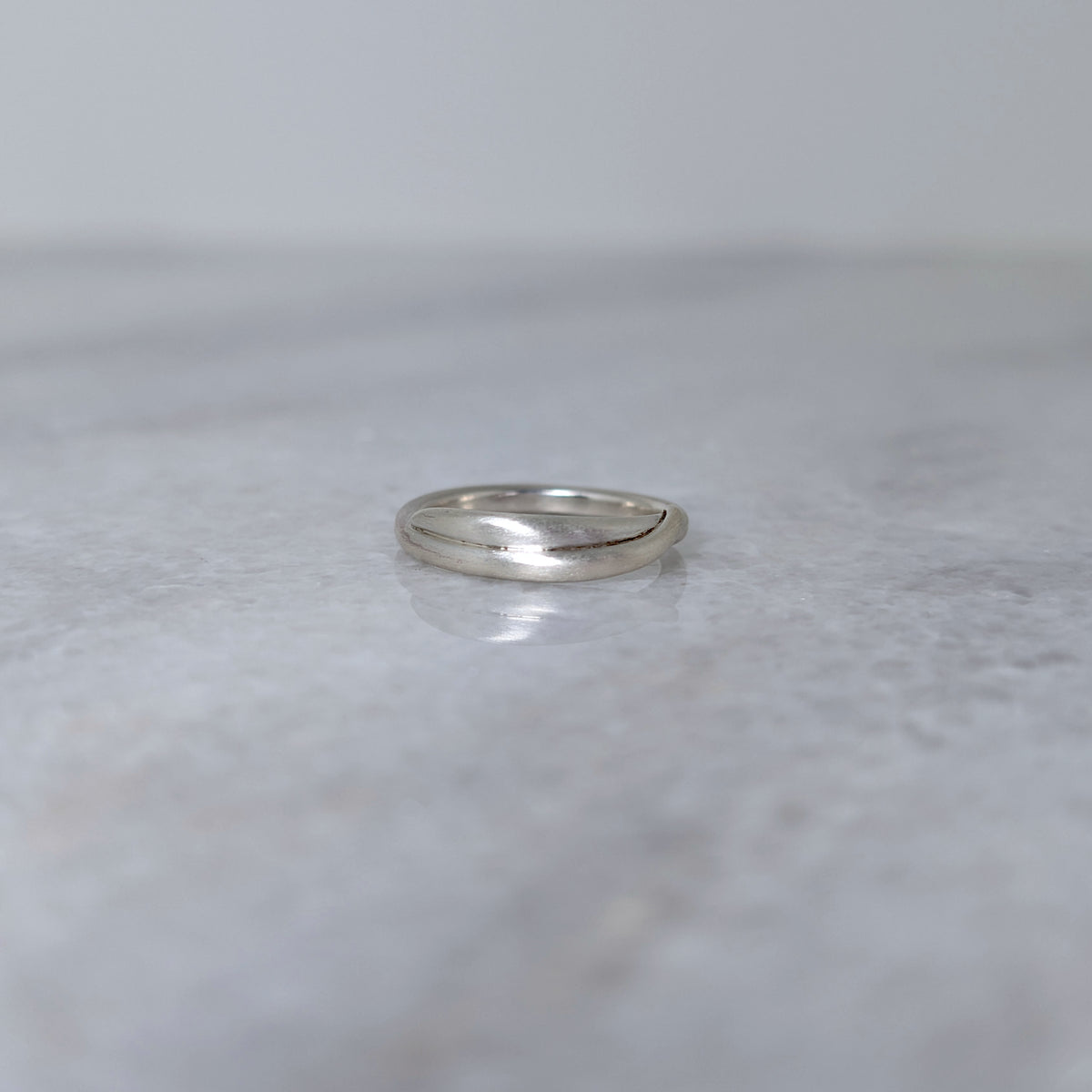 Silver vine ring on a marble surface