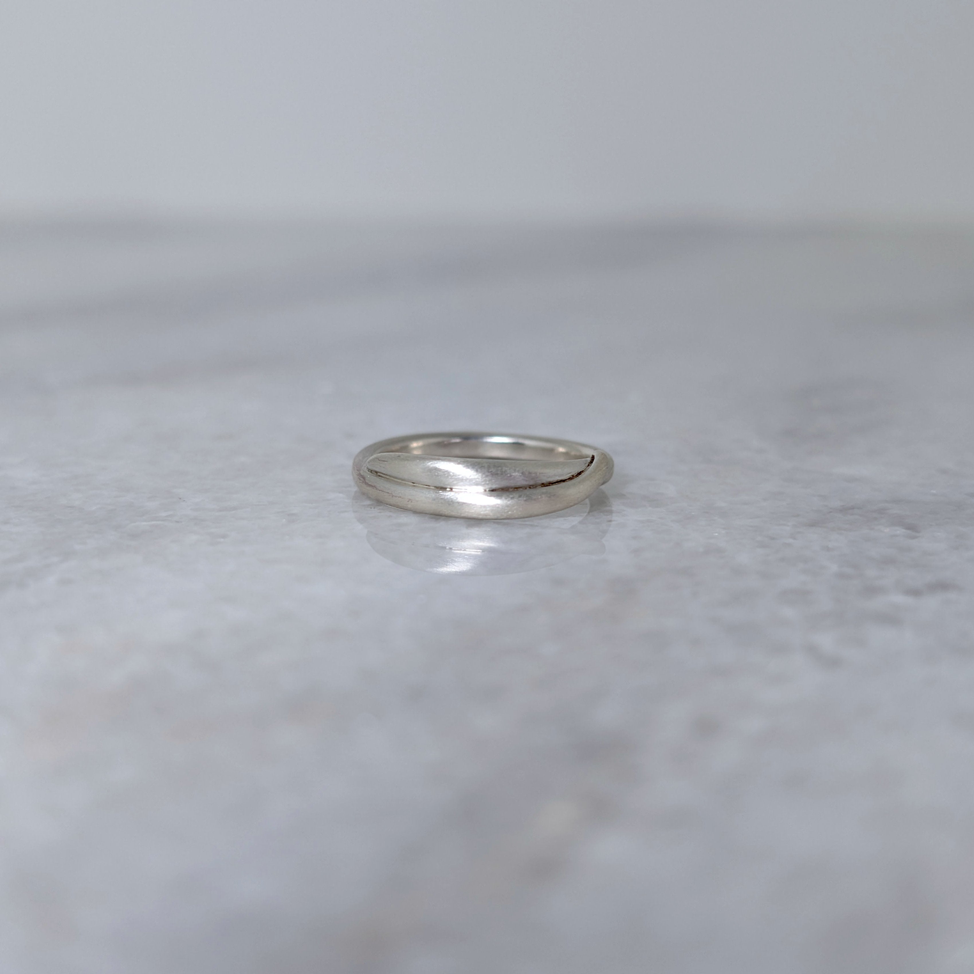 Silver vine ring on a marble surface