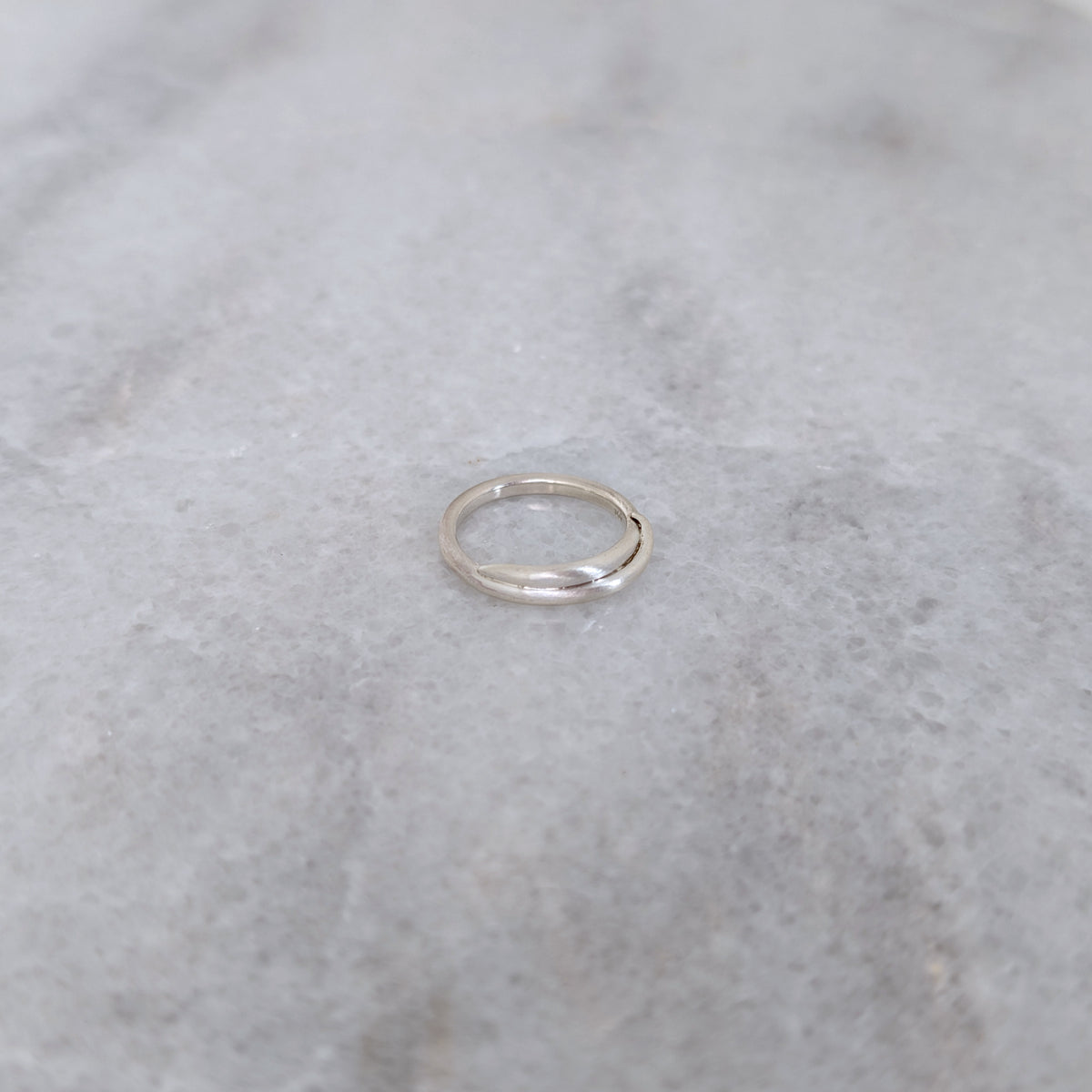 Silver vine ring on a marble surface