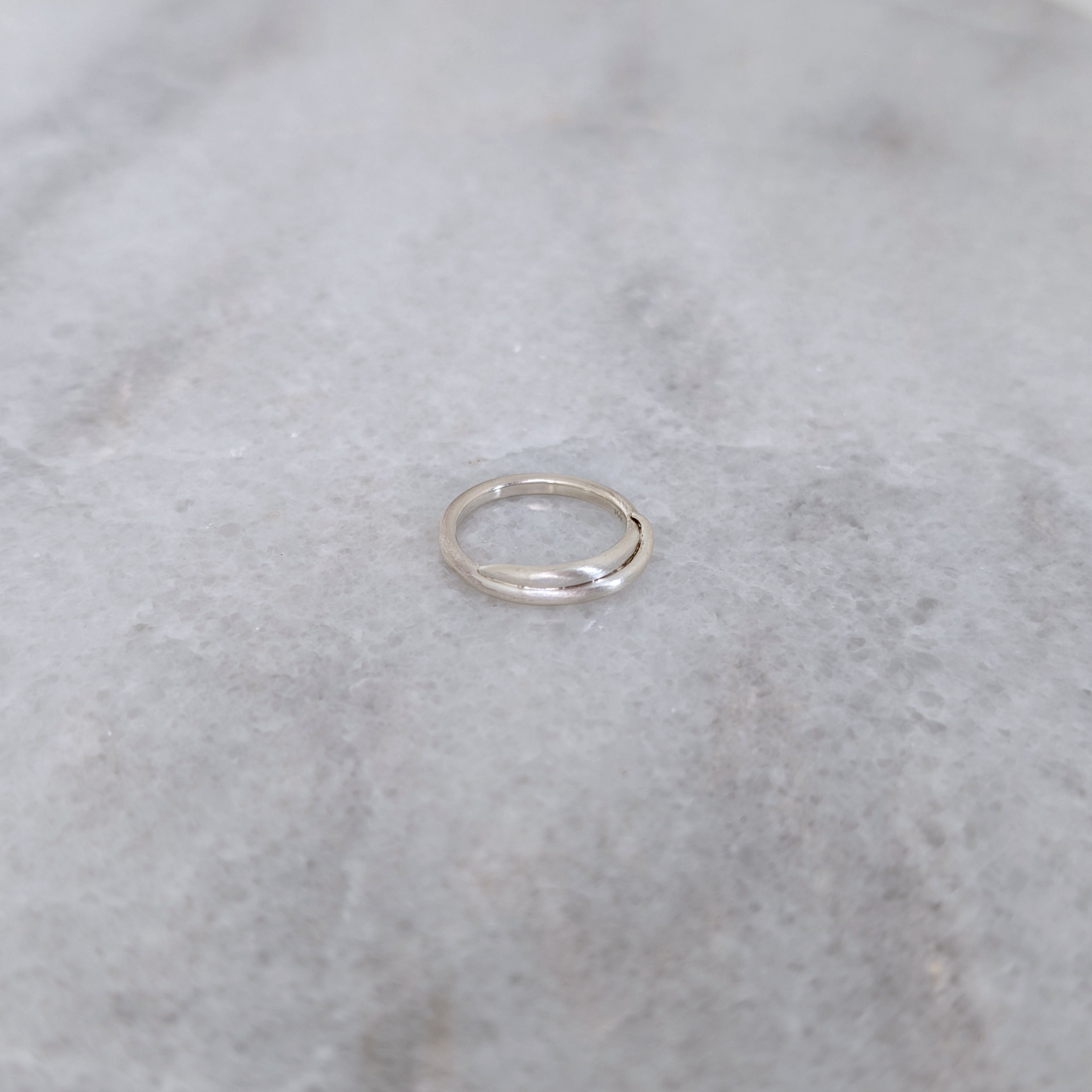Silver vine ring on a marble surface